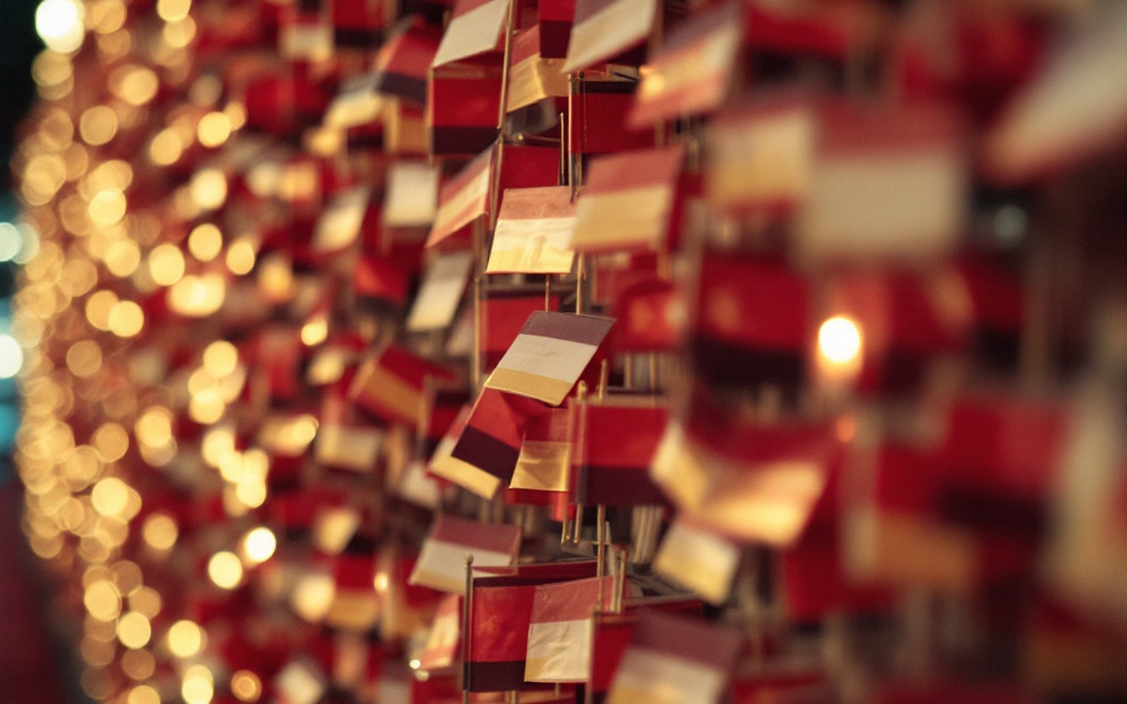 A wall of small identical flags, out of focus, close